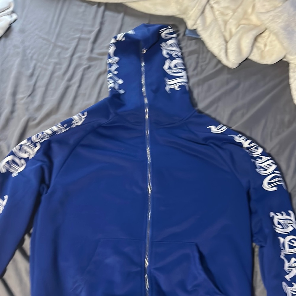 blue zip up with white writing